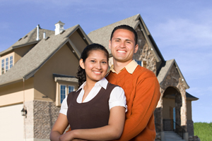 Couple standing in front of home